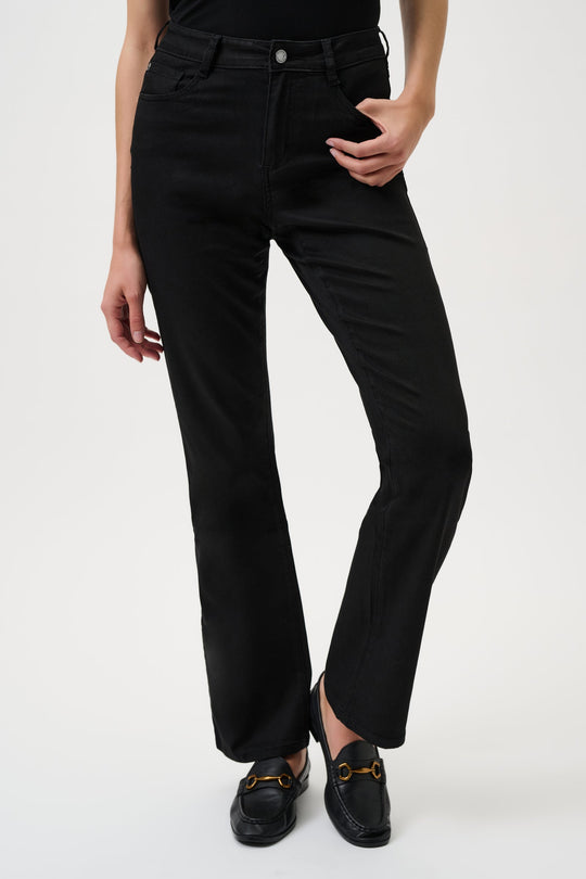 Person wearing black pants on a white background