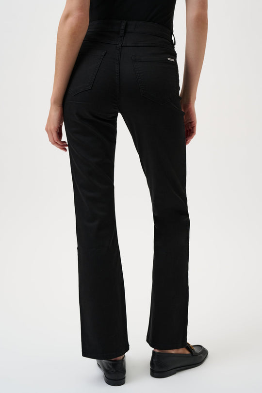 Person wearing black pants on a white background